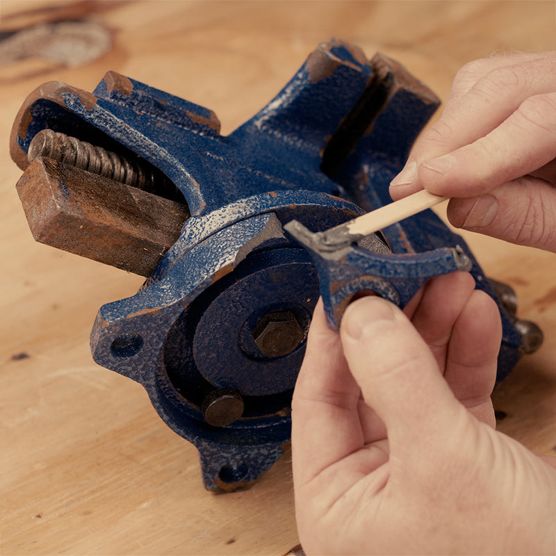 Applying J-B Weld epoxy to repair a cracked engine part